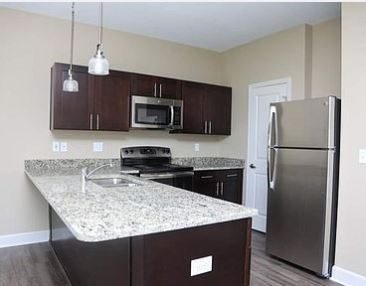 Finished kitchen, custom cabinetry and full height stone backsplash